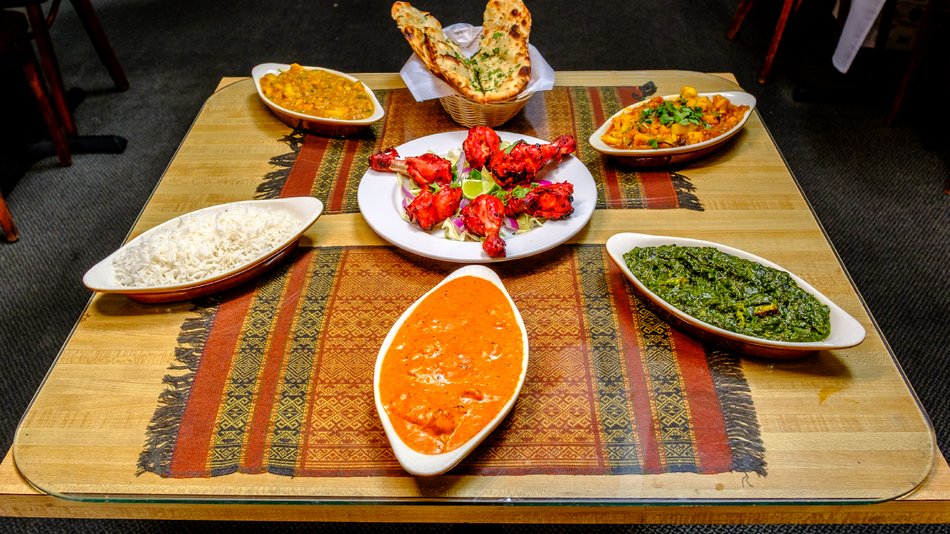 Tibet Nepal House Restaurant – table spread of curries, rice, tandoori chicken and naan.