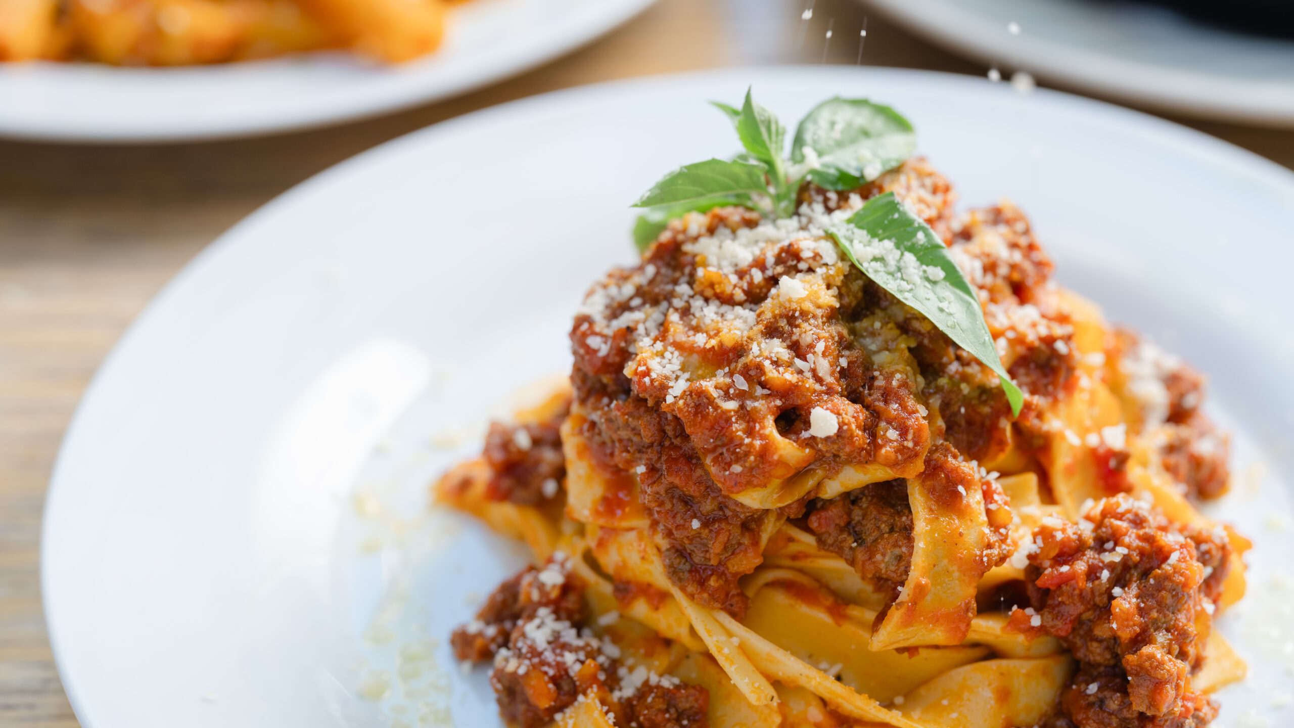 Caffe Italia – plate of fresh tagliatelle bolognese topped with parmesan and basil.