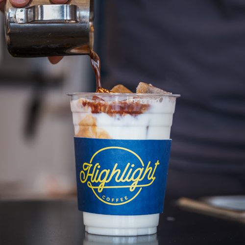 Photo of barista preparing a latte at Highlight Coffee